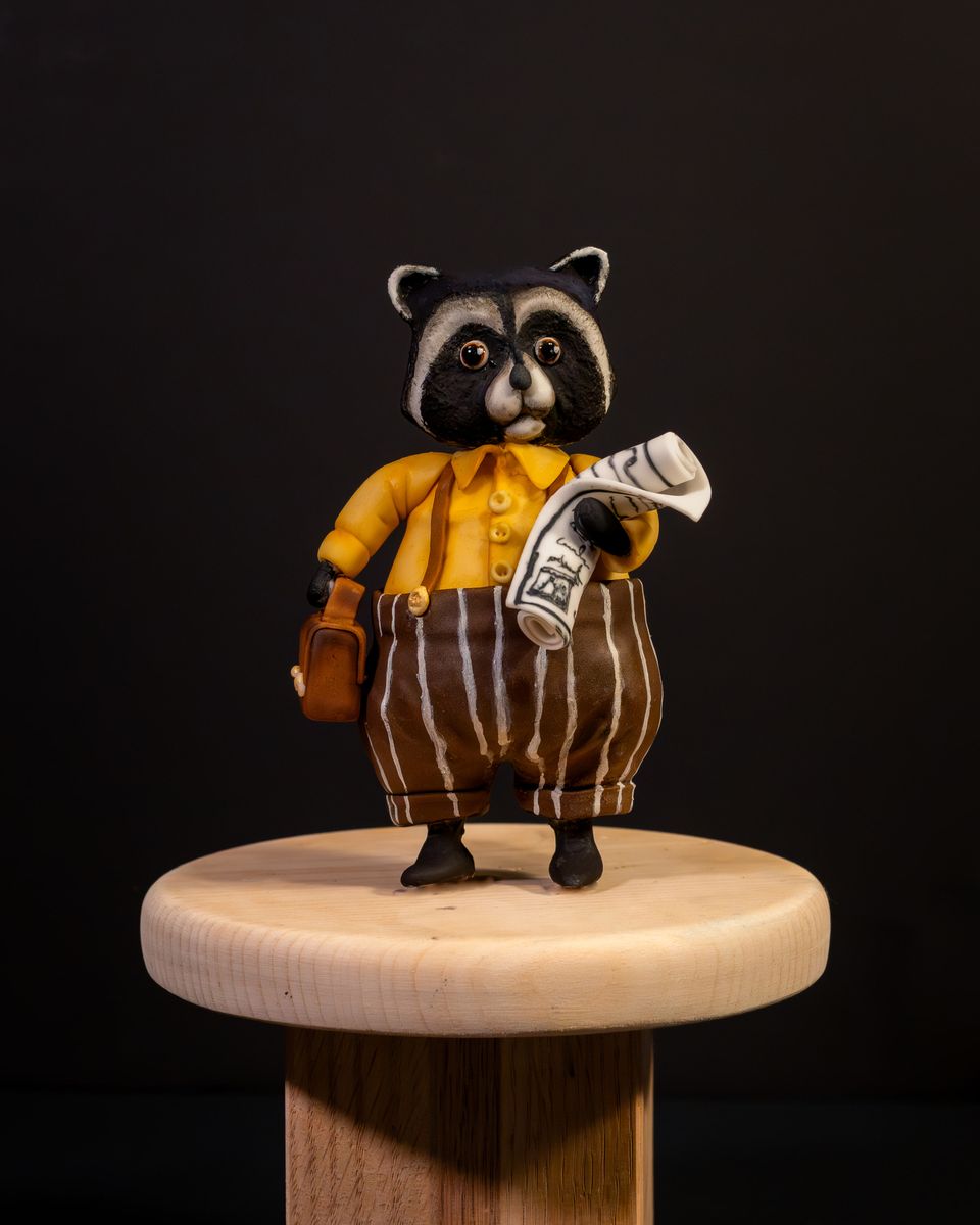 Raccoon with newspaper